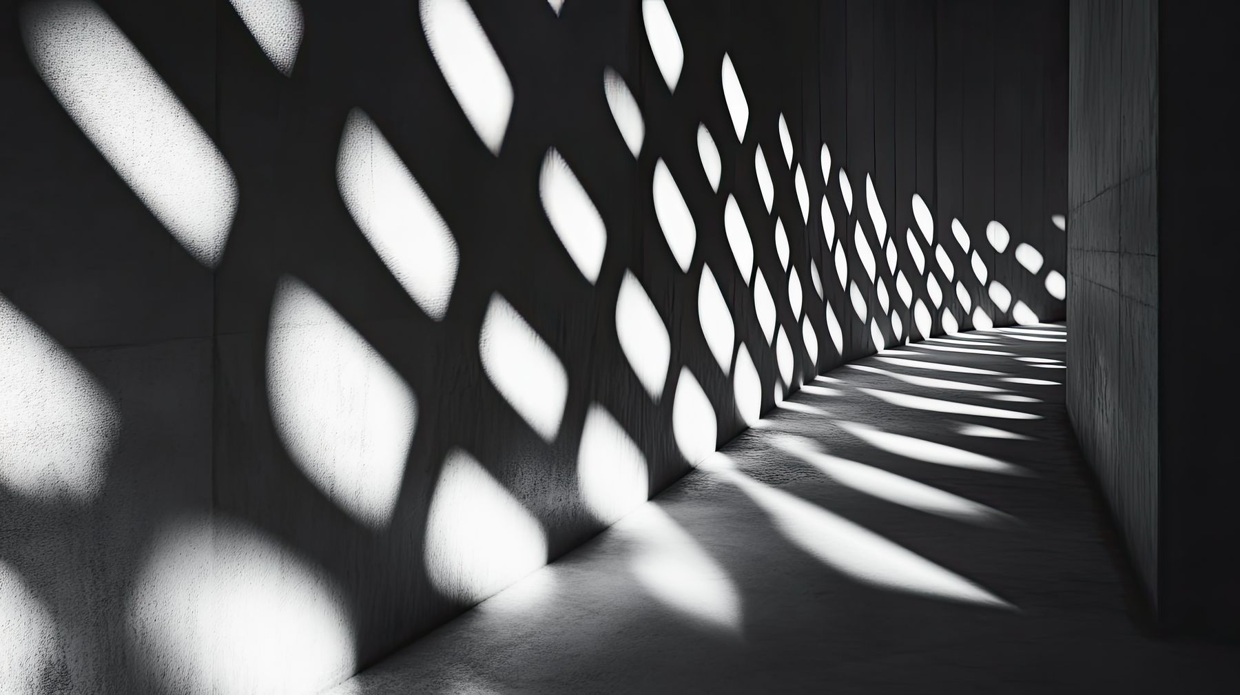 Light falling in a repeating pattern along a concrete corridor